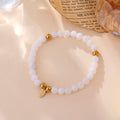 Bracelet Aurea élastique perles blanches femme